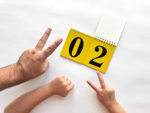 Creative countdown with hands and calendar on white background Stock Photos