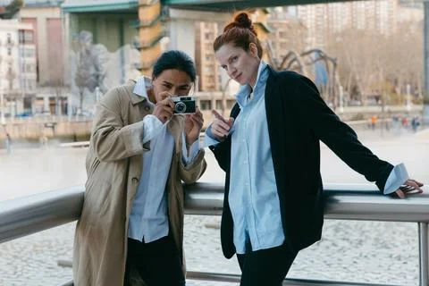Creative couple with camera capturing city moments. Stock Photos