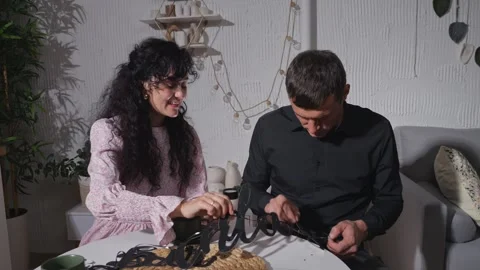 Creative couple collaborating on assembling wooden home decor Video stock 303878740