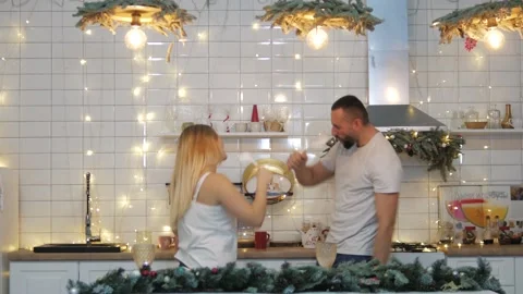 Creative couple dance and sing together in the kitchen. Fancy funny young people Stock Footage 146160429