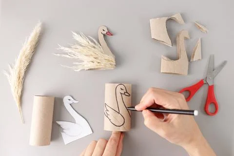 A creative craft project in progress. a hand is holding a pencil and drawin.. 스톡 사진