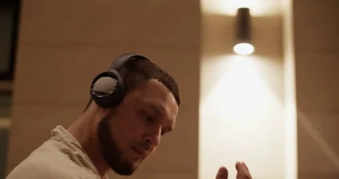 Creative dancer in headphones performing on night street Stock Footage 244474665