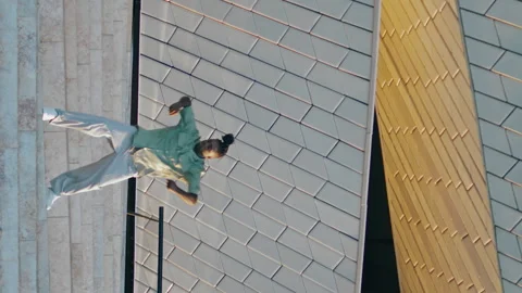 Creative dancer performing contemporary bunch on stairs vertical. Guy moving Stock Footage 247927349