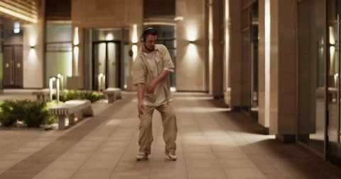 Creative dancer performing on glowing street at night Stock Footage 244475277