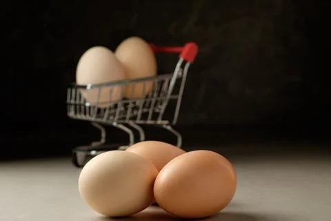 Creative dark display of uniquely arranged eggs in a cart Stock Photos