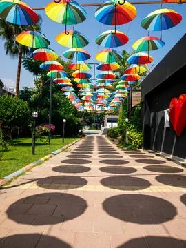 Creative decorative vertical background from many rainbow color sun umbrella Stock Photos