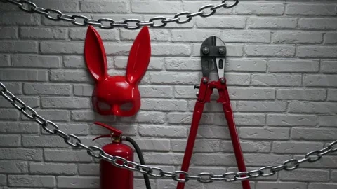 Creative design of a fire brick wall with a rabbit mask, fire extinguishers and Stock Footage 142734671