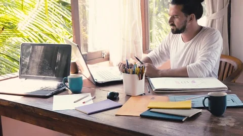 Creative design man develops ideas and looking laptop Stock Footage 74436918