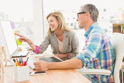 Creative design team working together on computer Stock Photos