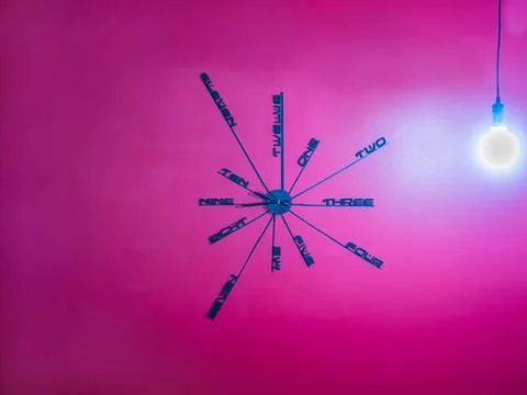 Creative design wall clock on red concrete wall Stock Photos