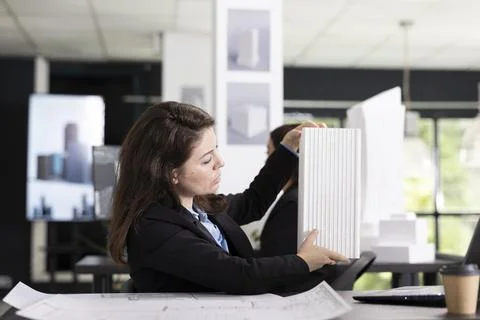Creative designer with 3d building model on video call with contractors Stock Photos