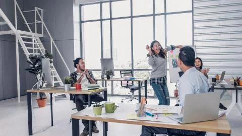 Creative designer dancing in office, get good new about promote to manager. c Stock Photos