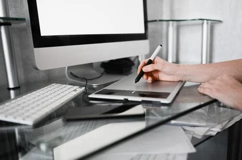 Creative designer hands working on laptop with graphic tablet. Stock Photos