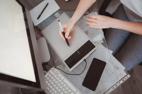 Creative designer hands working on laptop with graphic tablet. Stock Photos
