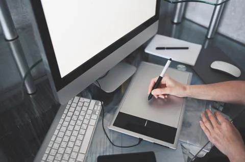 Creative designer hands working on laptop with graphic tablet. Stock-Fotos