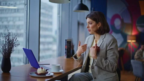 Creative designer having video call laptop in cafe closeup. Remote work meeting Stock Footage 335316000
