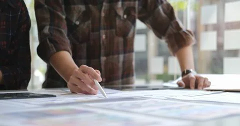 Creative designer man and developer are working together to develop mobile re Stock Photos