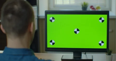 Creative Designer Sitting at His Desk Uses Desktop Computer with Two Green Mock Video stock 129452110