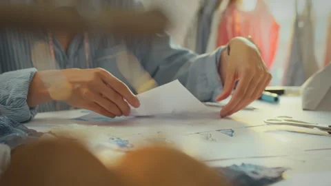 Creative designer sketching and planning fashion patterns in a studio during Stock Footage 289578246