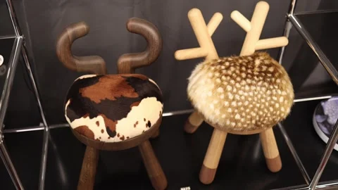 Creative designer stools with wooden legs and animal inspired fur seats displaye Stock Footage 318869629