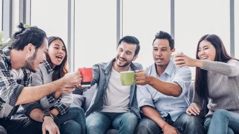 Creative designer take coffee break and toasting coffee cup at office cafeter Stock Photos