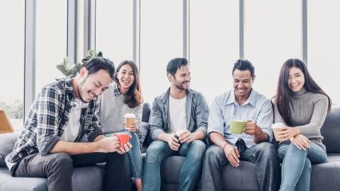 Creative designer take coffee break at office cafeteria. multiethnics employe Stock Photos