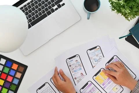 Creative designer working on development project for mobile application at Stock Photos