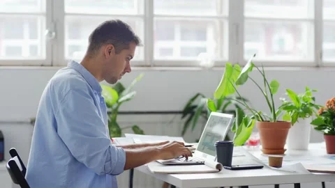 Creative designer working on laptop in studio Stock Footage 142510651