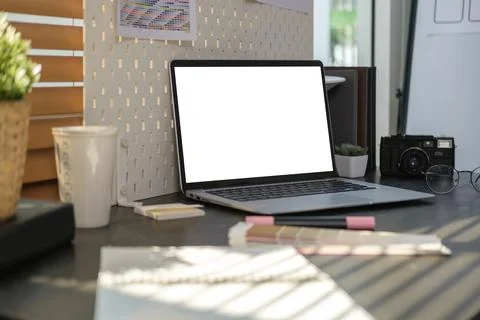 Creative designer workplace with laptop computer, color samples and camera .. Stock Photos