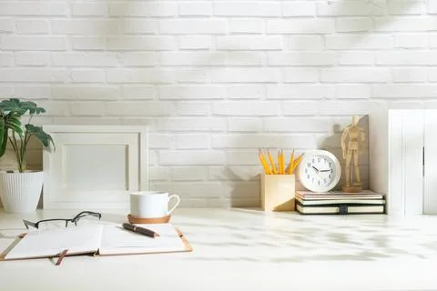 Creative designer workplace with picture frame mock up stationery and potte.. Stock Photos