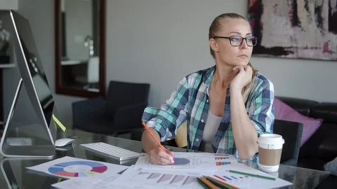 A creative designer works for a computer and drinks coffee Stock Footage 101851286