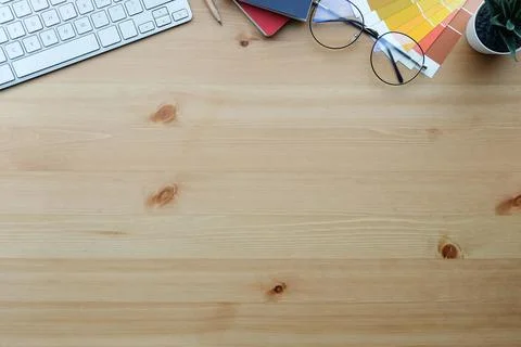 Creative designer workspace with colour swatch, coffee cup, notebook and glas Stock-Fotos