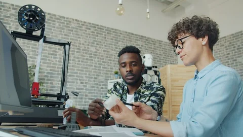 Creative designers engineering robot making parts using modern 3d printer Stock Footage 119559706