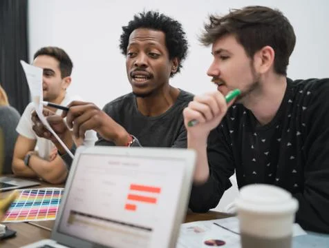 Creative designers working in a project together. Stock Photos