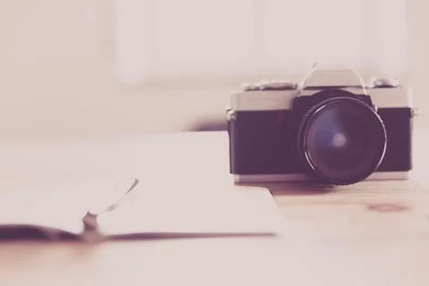 Creative desk with camera and notebook Stock Photos