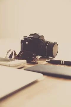 Creative desk with camera and notebook Stock Photos