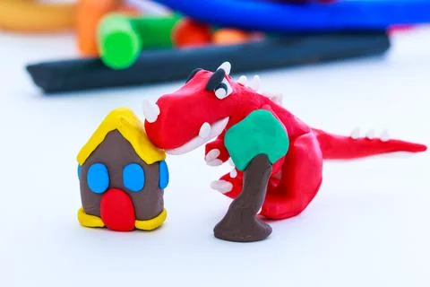 Creative dinosaur, house and tree clay model, on white background. Play dough Stock Photos