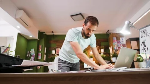 Creative director analysing his designs for his new project Stock Footage 113876812