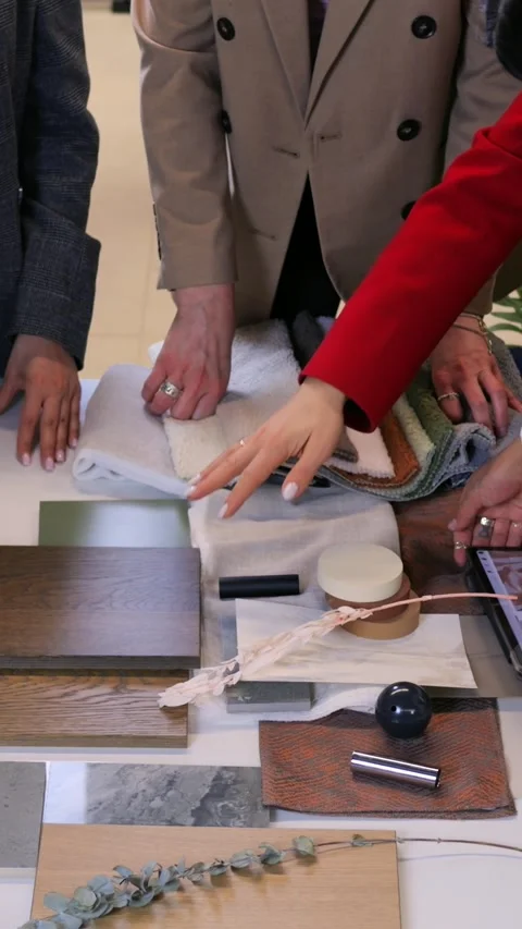 Creative director presenting digital moodboard on tablet while team selects Stock Footage 344743434