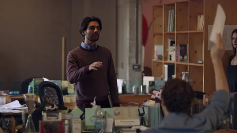 Creative director talking with his team and delegating tasks and assignments in Stock Footage 199456687