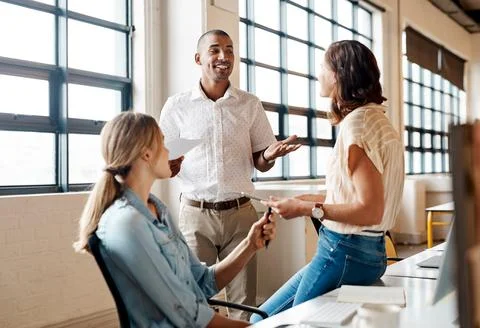 Creative, discussion and team in office with paper, ads feedback and review.. Stock Photos