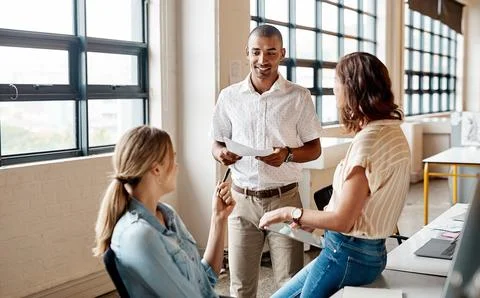 Creative, discussion or team in agency with paper, ads feedback or review o.. Stock Photos