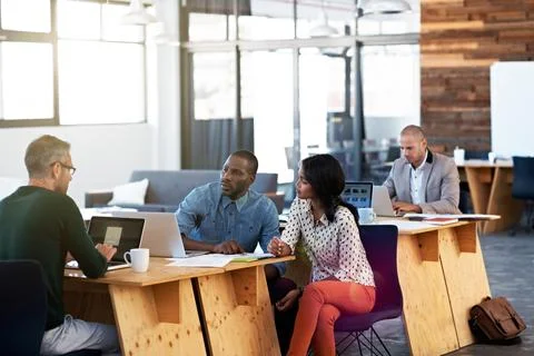 Creative, discussion or team in office with laptop, campaign pitch or review on Stock-Fotos