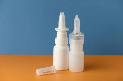 Creative display of two unique white cosmetic containers against a vibrant .. Foto stock