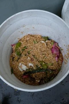 A creative DIY flowerpot compost bin recycling kitchen scraps on a small ba.. Stock-Fotos