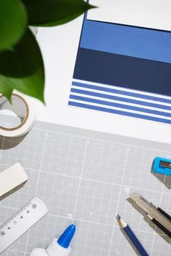 Creative DIY workspace with a utility knife, glue, ruler, and stationery for  Foto stock