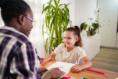 Creative drawing session between a teacher and a young student Stock Photos