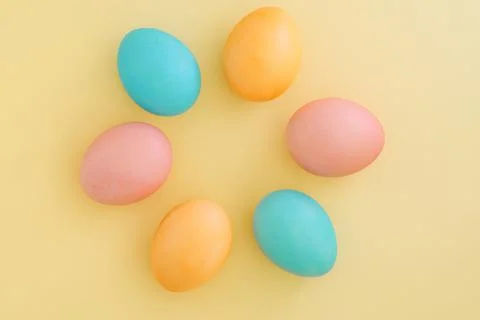 Creative easter background with colorful easter eggs laid out in flower shape on Stock Photos
