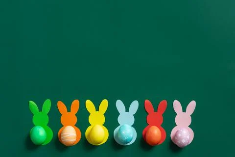 Creative Easter background with paper bunnies with colorful eggs instead of tail 스톡 사진