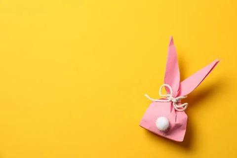 Creative Easter bunny gift bag on color background, top view with space for t Foto stock